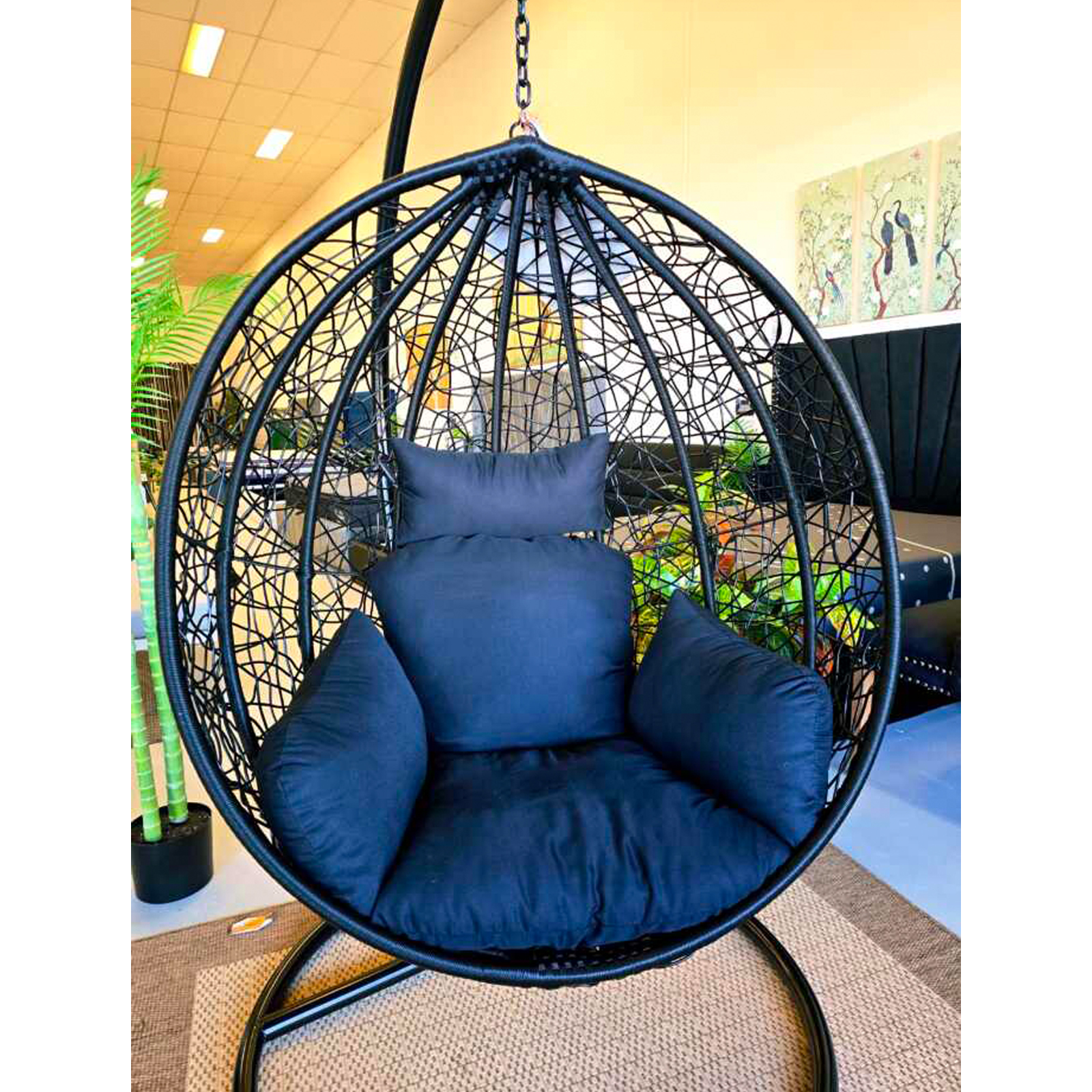 Bird nest single-seater egg chair in black rattan for outdoor relaxation