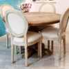 Lifestyle setup image of dining area with French Country beige linen armchair