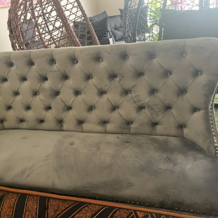 Zara grey velvet dining sofa with button-tufted backrest and wooden legs