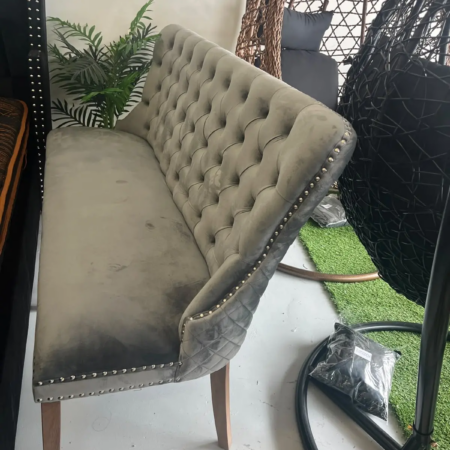 Zara grey velvet dining sofa with elegant curved backrest and tapered wooden legs