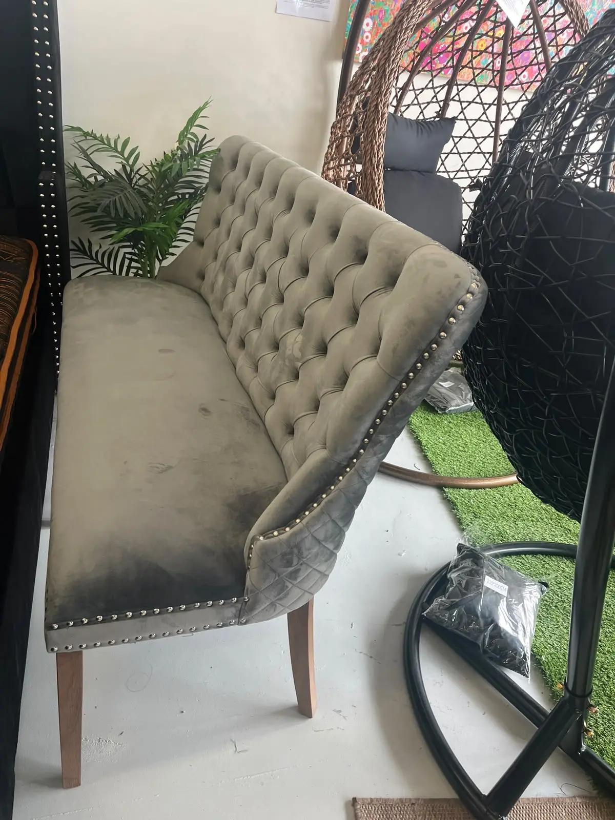 Zara grey velvet dining sofa with elegant curved backrest and tapered wooden legs